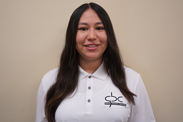 hotograph of Divine Jacobson in white GBC polo.