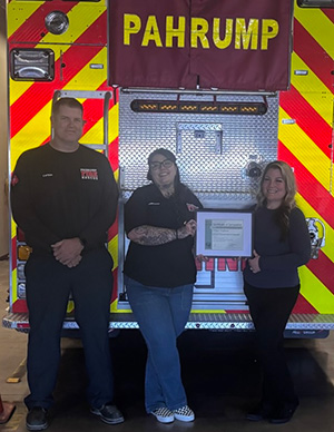 Stabdubg in front of a firetruck are Hillary Hoffman, Ashley Castillo and Scott Lewis.