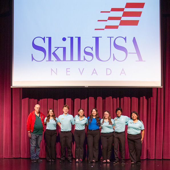 SkillsUSA conference at GBC. Seven students and an instructor on stage during the SkillsUSA conference.